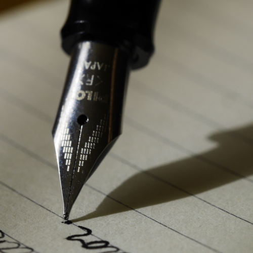 Pen writing on lined paper